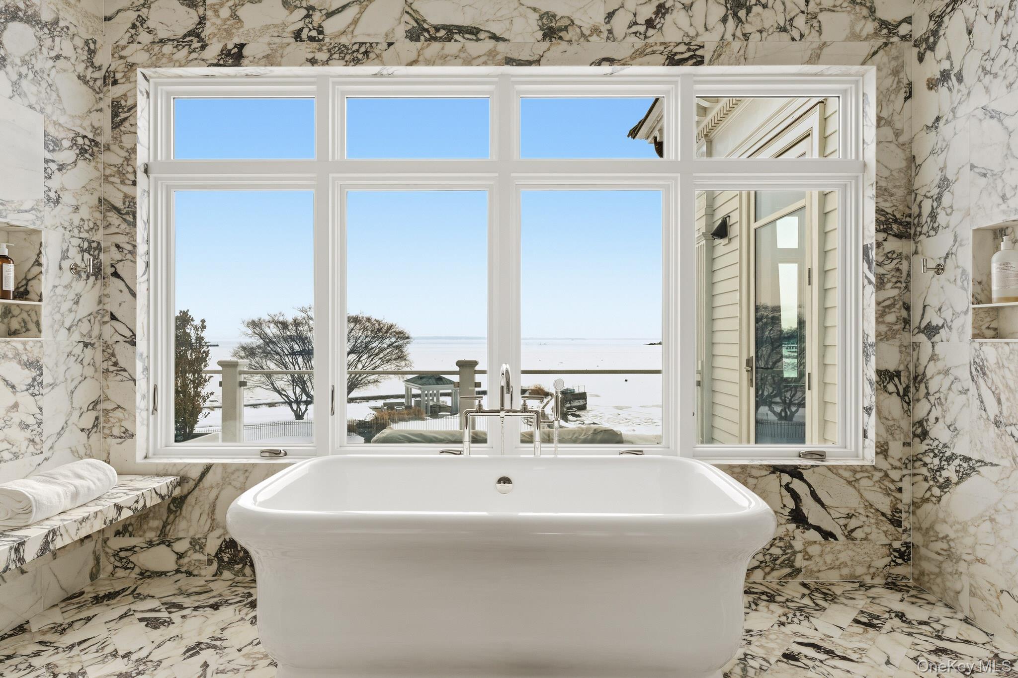 217 Hommocks Road Larchmont, NY 10538 - Photo 22 of 49 a bath tub sitting in a bathroom next to a window