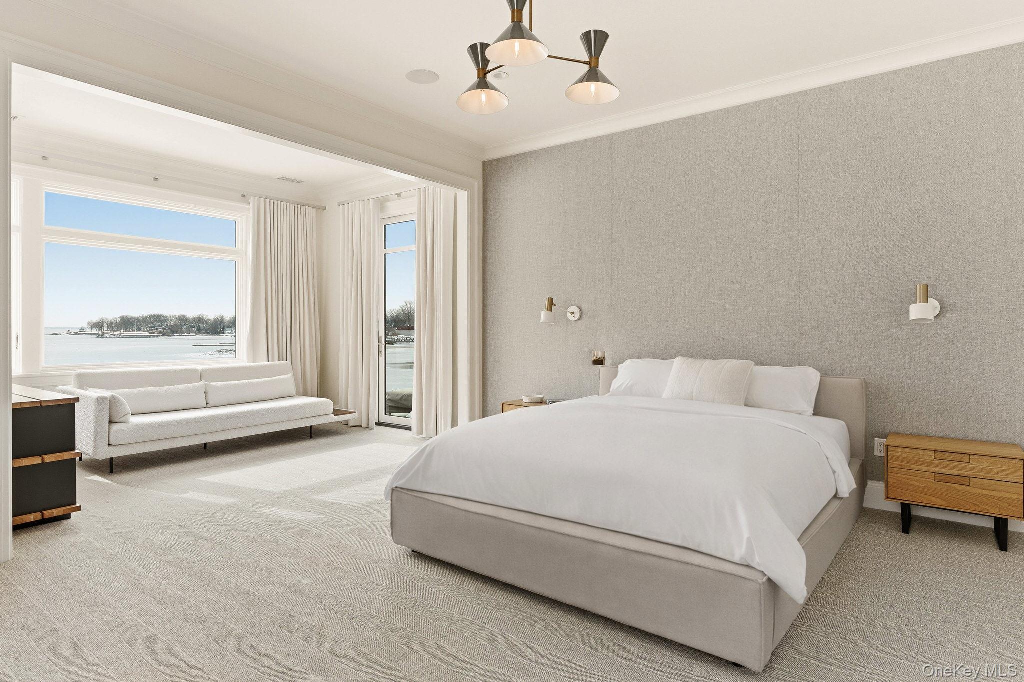 217 Hommocks Road Larchmont, NY 10538 - Photo 25 of 49 a spacious bedroom with a bed and a large window