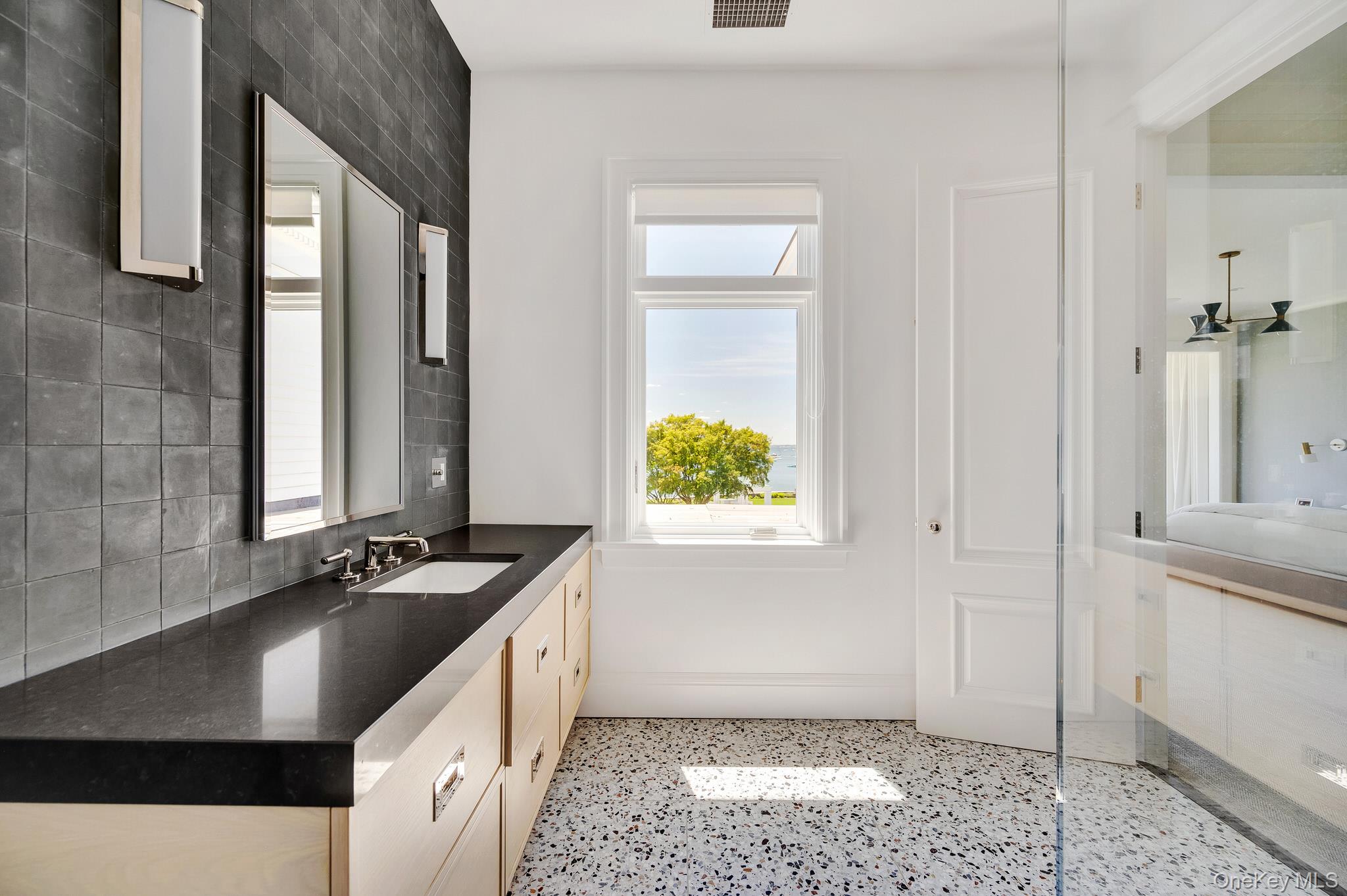 217 Hommocks Road Larchmont, NY 10538 - Photo 26 of 49 a kitchen with a sink stove and cabinets