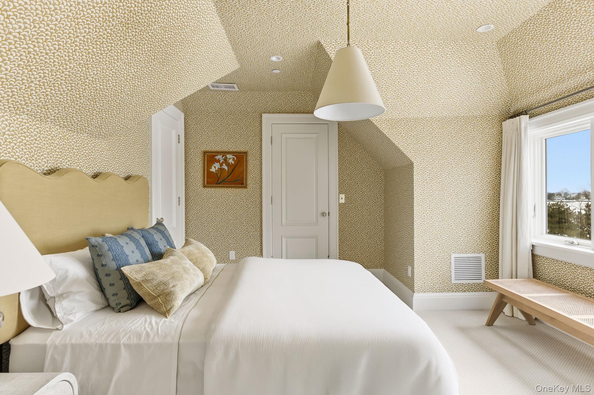 217 Hommocks Road Larchmont, NY 10538 - Photo 36 of 49 a bedroom with a bed and a chandelier