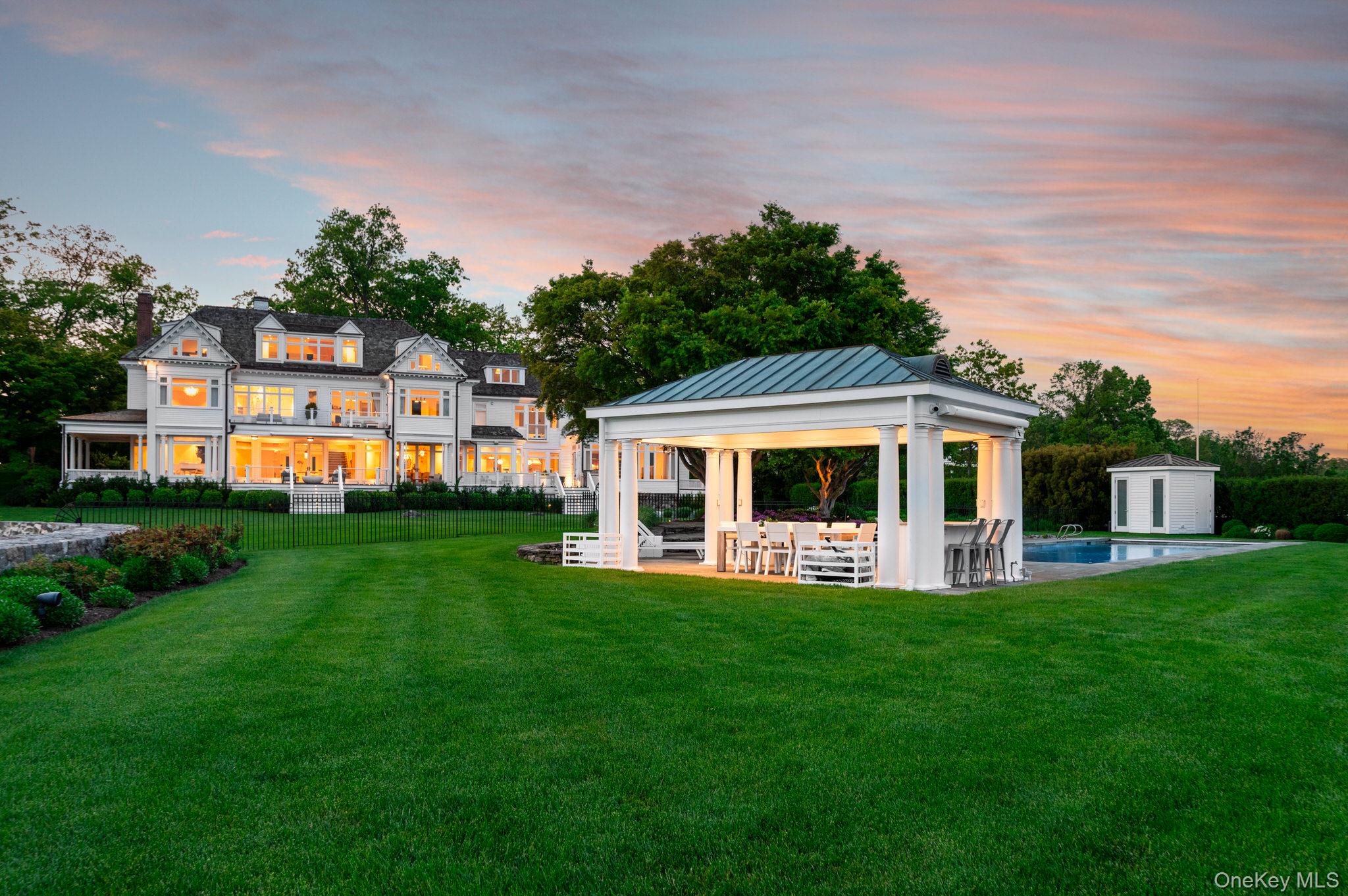 217 Hommocks Road Larchmont, NY 10538 - Photo 43 of 49 a front view of a house with a yard deck and green space