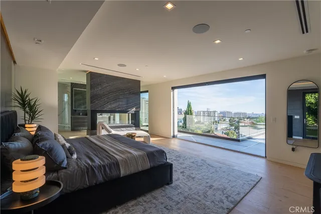 a bedroom with a large bed and a flat screen tv
