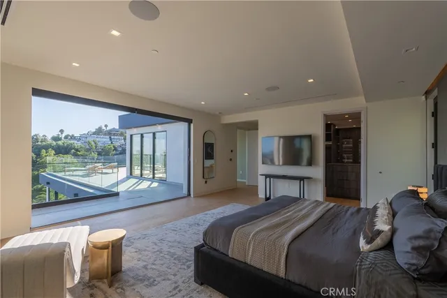 a living room with a large window and furniture