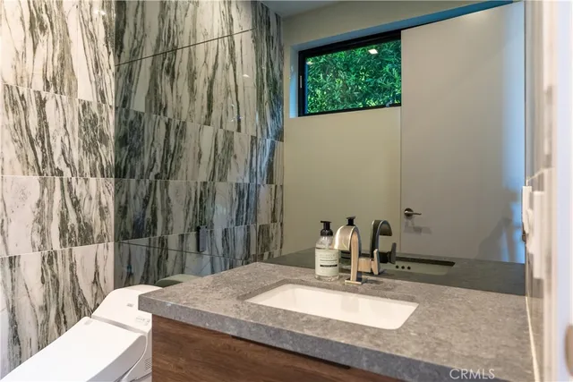a view of a patio with couches table and chairs under an umbrella