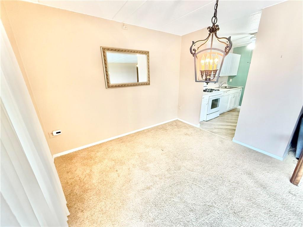 1160 Bower Hill Road, Unit 302C Mt. Lebanon, PA 15243 - Photo 12 of 39 a view of a hallway with wooden floor and a chandelier