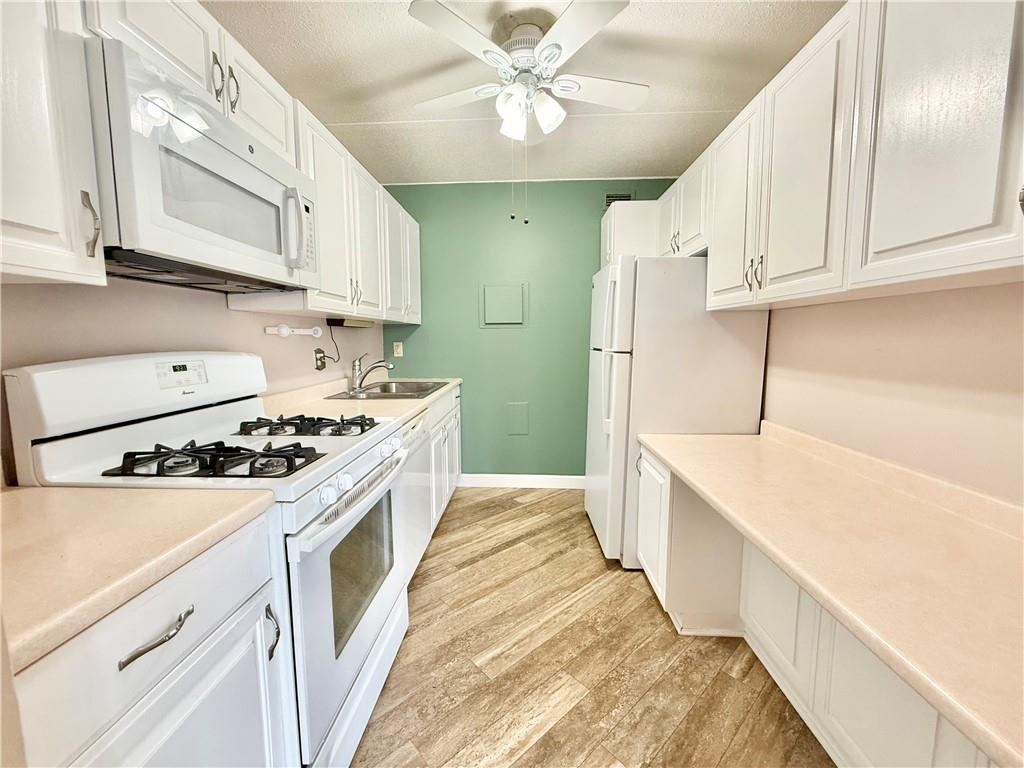 1160 Bower Hill Road, Unit 302C Mt. Lebanon, PA 15243 - Photo 13 of 39 a kitchen with white cabinets and white appliances