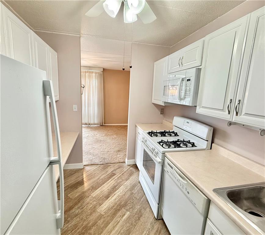 1160 Bower Hill Road, Unit 302C Mt. Lebanon, PA 15243 - Photo 14 of 39 a kitchen with a stove a refrigerator and a sink