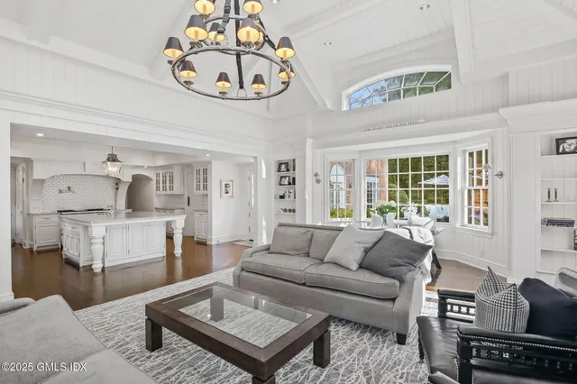 a living room with furniture and a chandelier