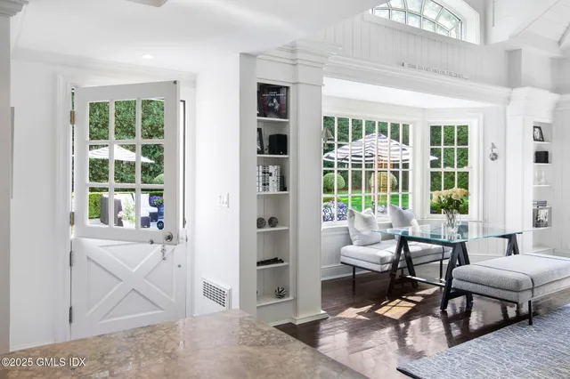 a living room with furniture and a floor to ceiling window
