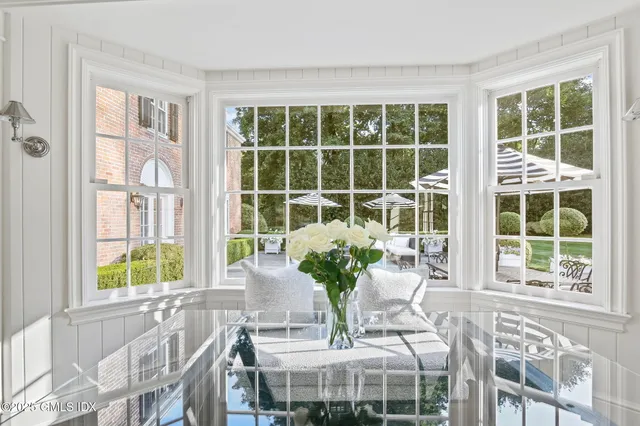 a view of a dining room with furniture and windows