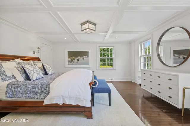 a bedroom with a large bed and window
