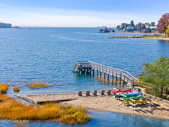 a view of swimming pool with outdoor seating and yard in the back