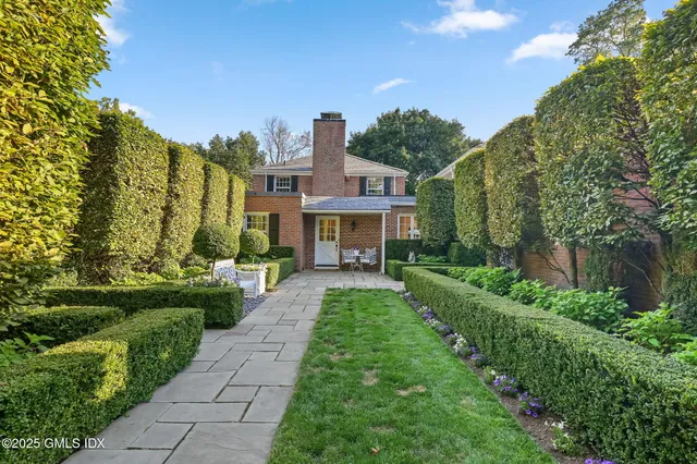a front view of house with yard and green space