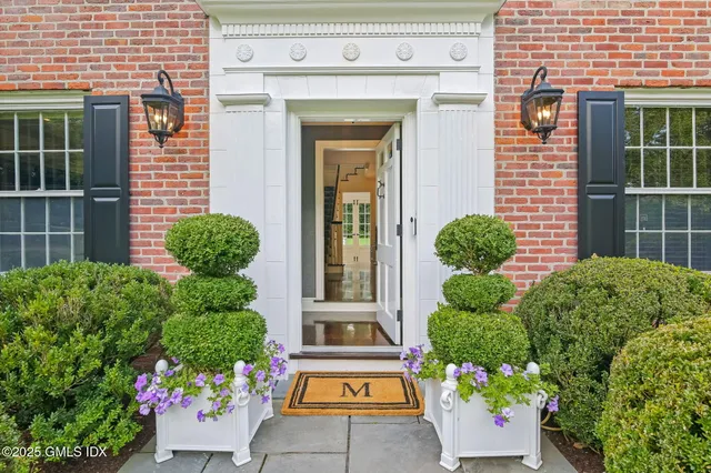 a view of a house with potted plants