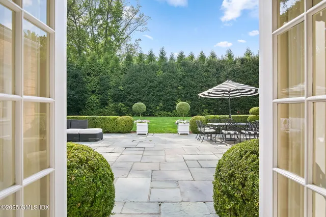 a view of a chair and tables in the balcony