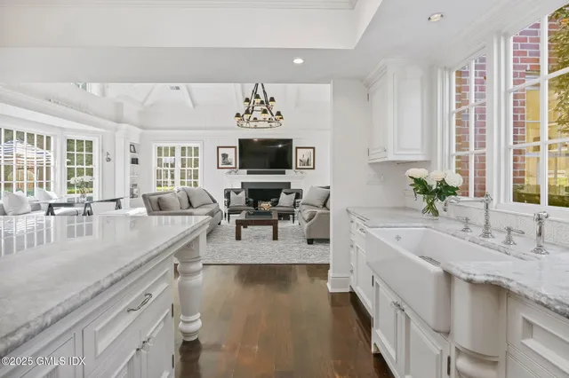 a large white kitchen with a large window