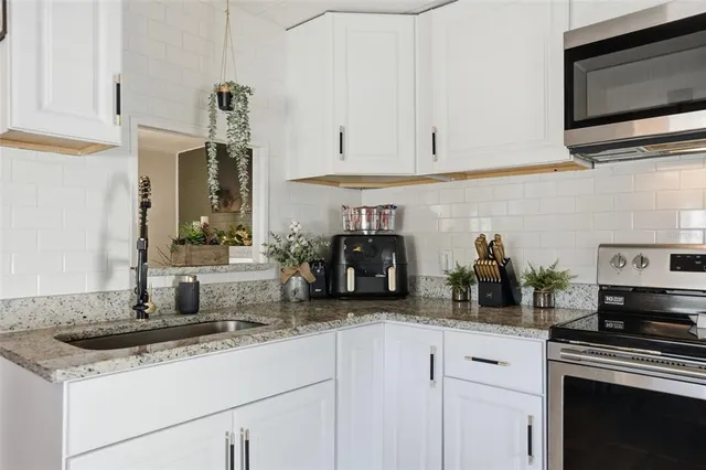 a kitchen with stainless steel appliances and cabinets