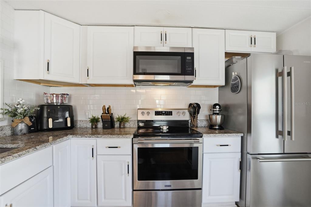 8055 Country Club Drive Brooksville, FL 34613 - Photo 14 of 33 a kitchen with stainless steel appliances and cabinets