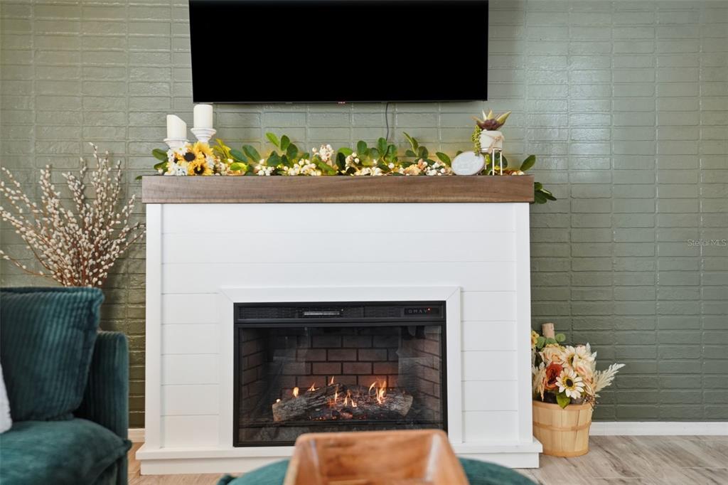 8055 Country Club Drive Brooksville, FL 34613 - Photo 9 of 33 a front view of a fireplace with wooden wall