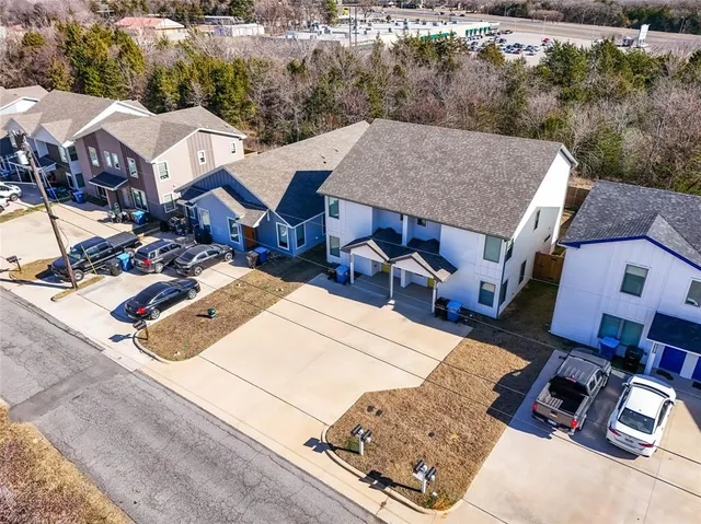 an aerial view of residential houses with outdoor space