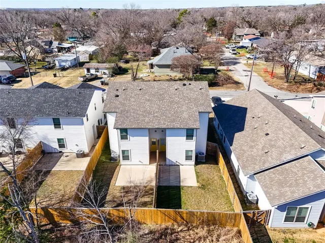 an aerial view of residential houses with outdoor space