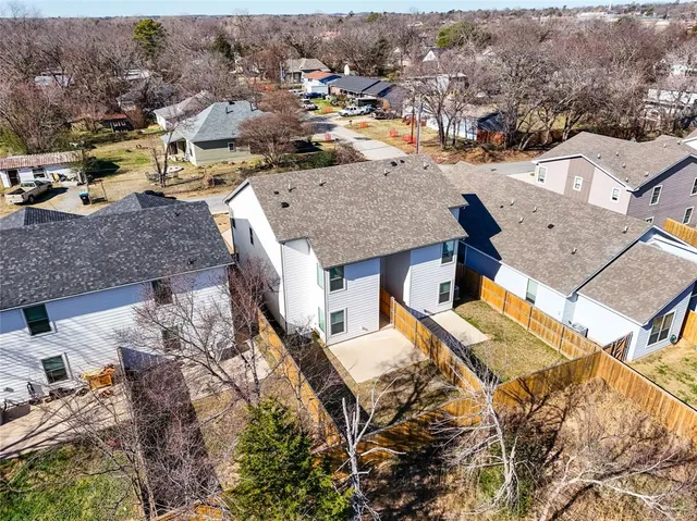 an aerial view of a house with swimming pool and furniture