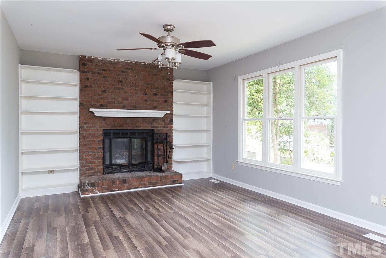 4216 Labrador Drive Raleigh, NC 27616 - Photo 2 of 20 wooden floor fireplace and windows in an empty room