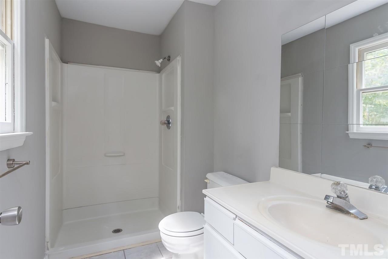 4216 Labrador Drive Raleigh, NC 27616 - Photo 13 of 20 a bathroom with a sink toilet and shower