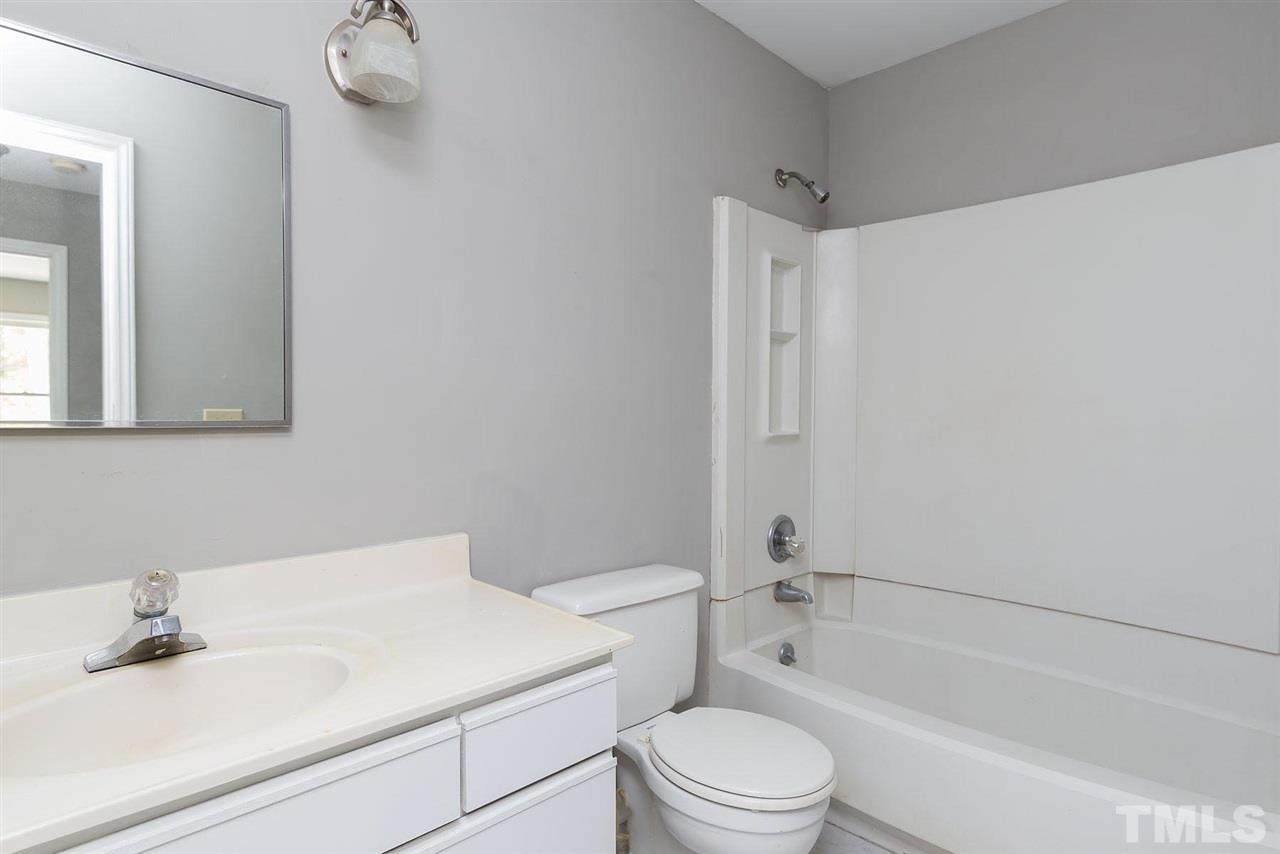 4216 Labrador Drive Raleigh, NC 27616 - Photo 14 of 20 a bathroom with a sink toilet and shower