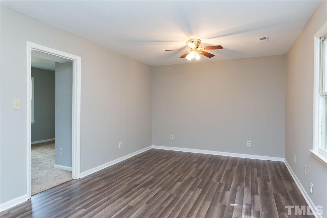 4216 Labrador Drive Raleigh, NC 27616 - Photo 15 of 20 a view of an empty room with wooden floor and a window