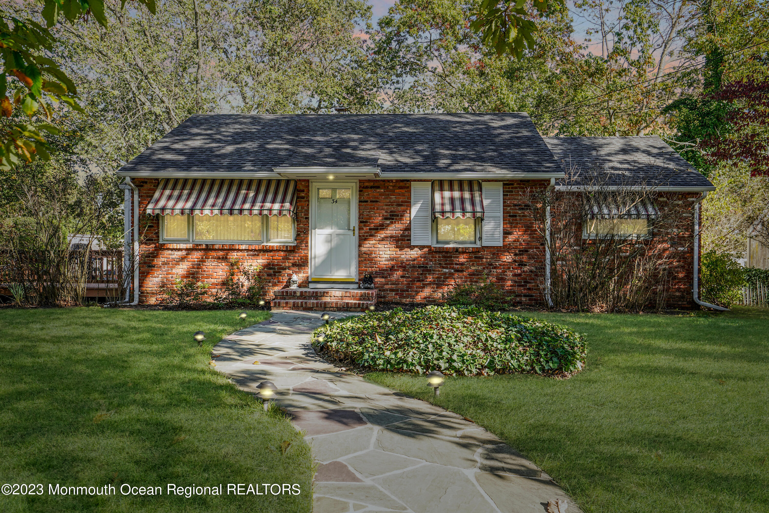 34 Hemlock Road Howell, NJ 07731 - Photo 1 of 1 a view of a backyard with plants and large trees