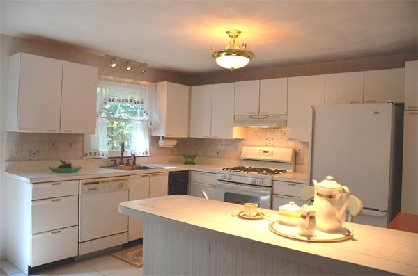 9 Oak Ridge Drive, Unit 5 Maynard, MA 01754 - Photo 6 of 20 a kitchen with a sink a stove a refrigerator and cabinets