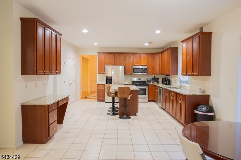 4 Lewis Hollow Road Randolph, NJ 07945 - Photo 7 of 10 a kitchen with stainless steel appliances granite countertop a stove a sink a microwave and a refrigerator