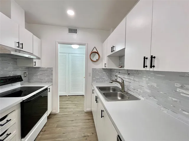 a kitchen that has a sink and a stove