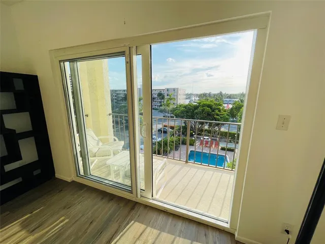 a view of a glass door and wooden floor