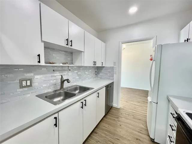 a kitchen with a sink and cabinets