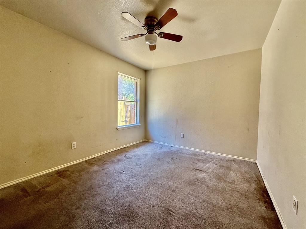 1144 Switchgrass Lane Crowley, TX 76036 - Photo 8 of 17 a view of a room with a ceiling fan and a window