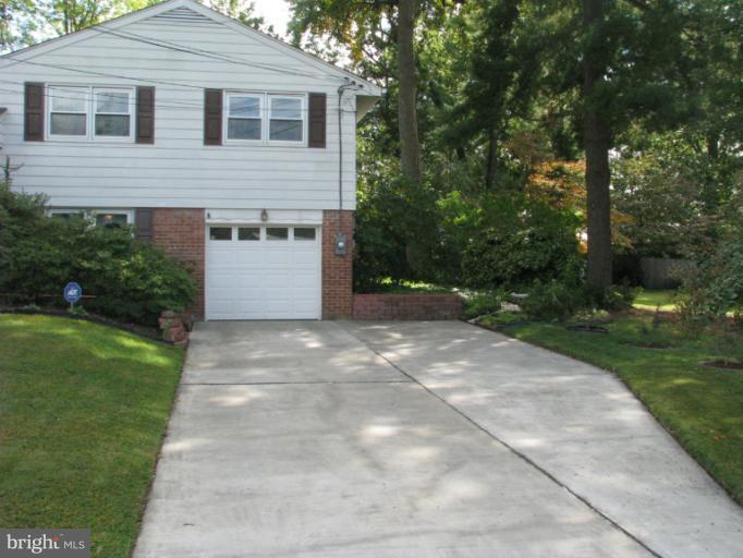 7425 Elgar Street Springfield, VA 22151 - Photo 22 of 28 a front view of a house with a yard and trees