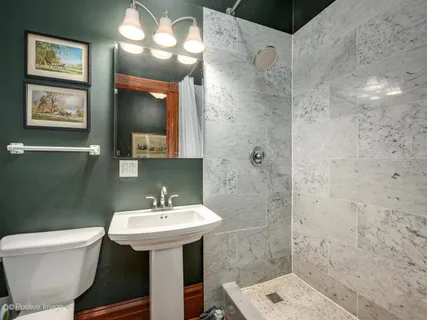 a bathroom with a sink toilet and a mirror