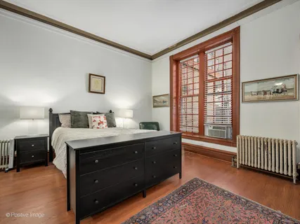 a spacious bedroom with a bed and a window