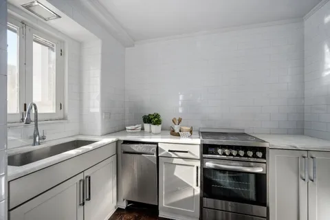 a kitchen with a sink stove and cabinets