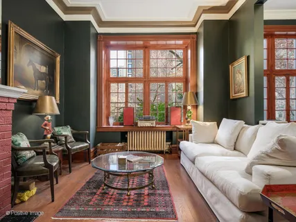 a living room with furniture and a floor to ceiling window