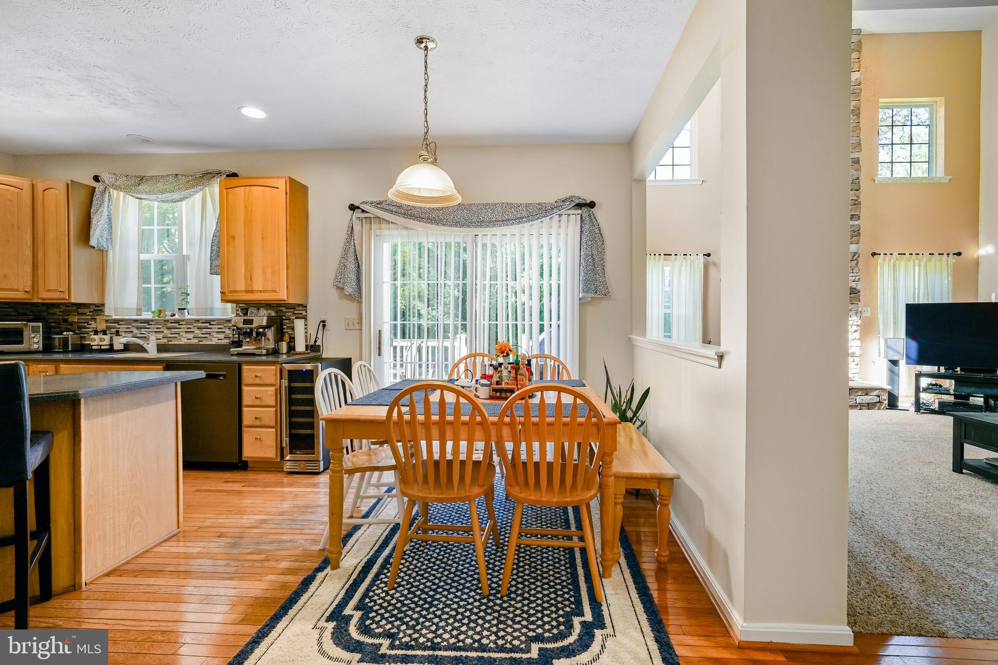 41 Austins Way Elkton, MD 21921 - Photo 18 of 47 a open kitchen with stainless steel appliances granite countertop a stove top oven a refrigerator a dining table and chairs with wooden floor