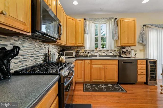 a kitchen with sink a stove and cabinets