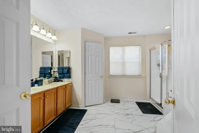 a bathroom with a sink a mirror and a shower
