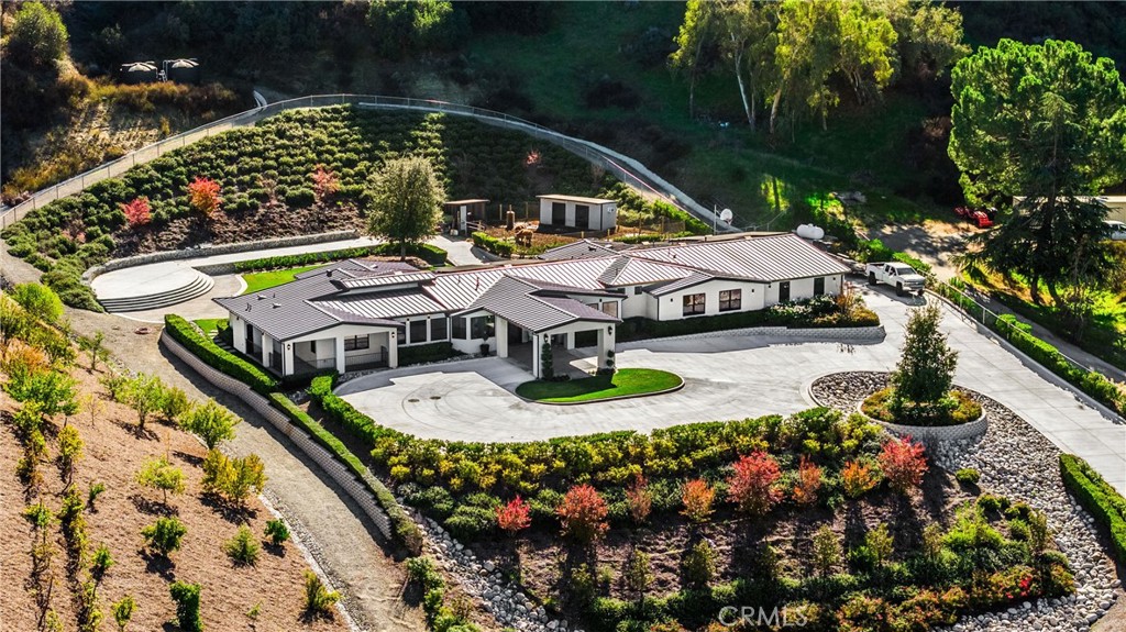an aerial view of a house with swimming pool a yard and outdoor seating