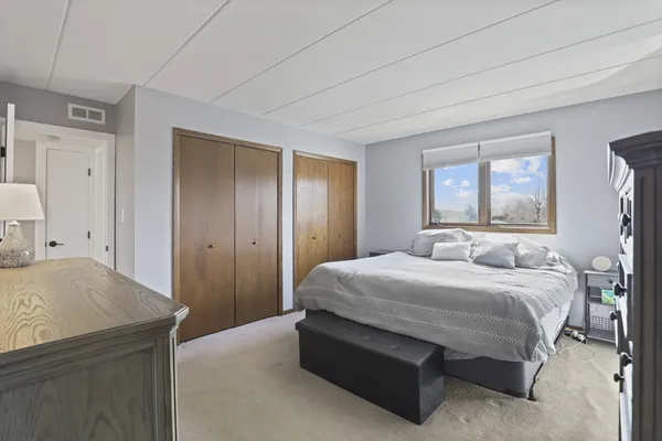 a bedroom with a bed and a dresser