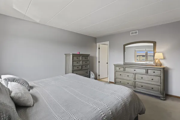 a bedroom with a bed and a dresser
