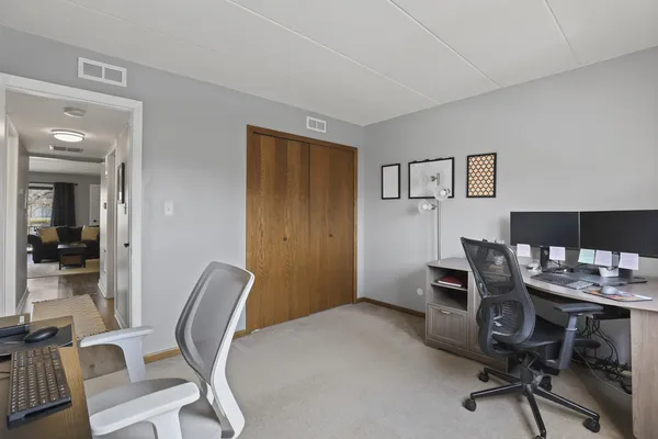 a view of a workspace with furniture and wooden floor