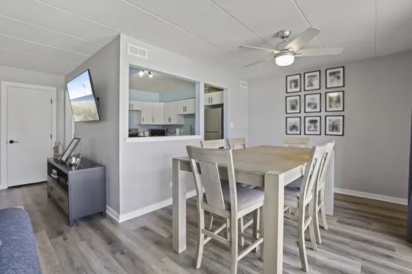 a view of a dining room with furniture and wooden floor